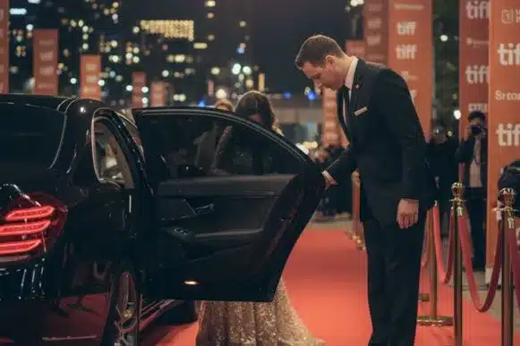 Toronto Limo Rentalsauffeur opening luxury sedan door for VIP guest during TIFF.